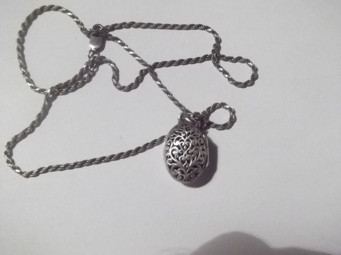 a silver locket with a silver chain
