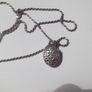 a silver locket with a silver chain Image 2