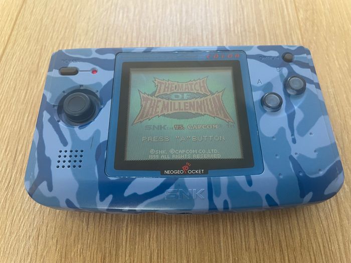 Neo Geo Pocket Color with game SNK vs. Capcom: Match of the Millennium