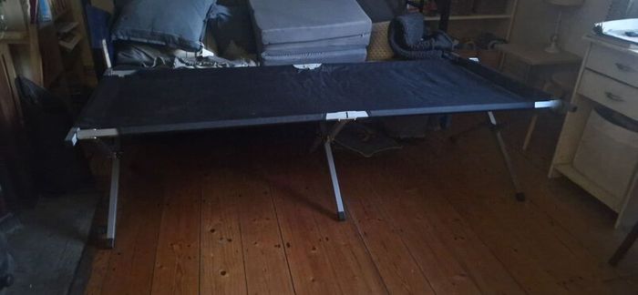 Camp bed/high off the floor. Strong army quality.