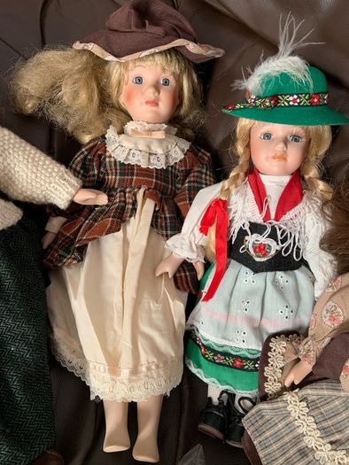 5 porcelain dolls with extra clothing perfect condition