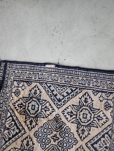 tiny wool rug...small mark on fringe.
