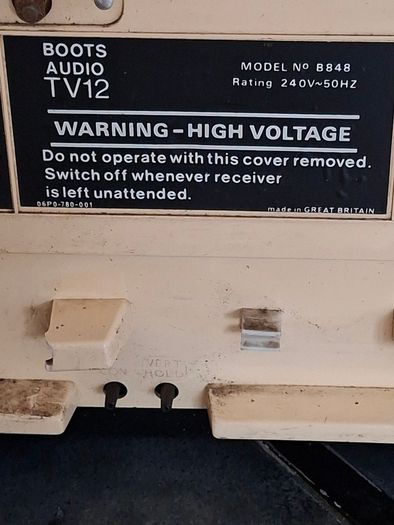 Ideal Prop, Vintage Working Boots Audio TV12 Portable Black and White CRT Television, featuring a cream plastic casing with side control dials and a 12 inch screen. Designed with dual power capabilities supporting standard mains voltage (240V) as well as 