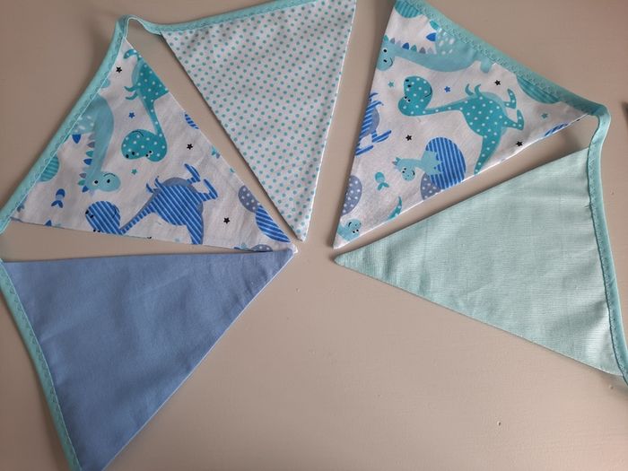 Dinosaur buntings . Blue and pink