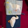 Baby sensory books and a rattle toy Image 3