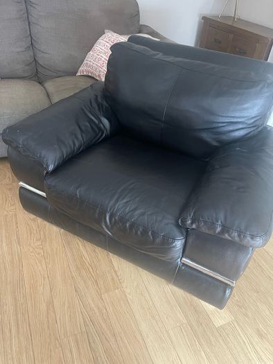 black Leather Armchair featuring plush pillow top arms and chrome accent feet need gone ASAP due to house clearance