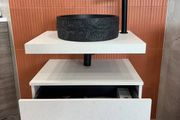 Modern wall-mounted vanity unit with black basin and tap