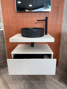 Modern wall-mounted vanity unit with black basin and tap