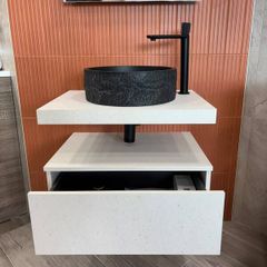 Modern wall-mounted vanity unit with black basin and tap