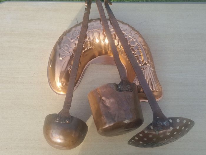 Vintage-style copper cookware and kitchen accessories.