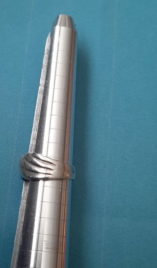 Silver ring clasping hands