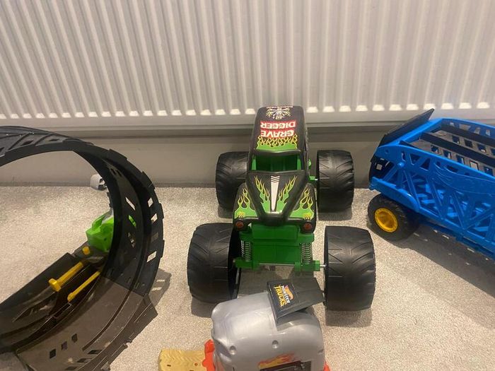 Hot Wheels Monster Trucks collection with transporter and track