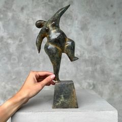 Solid bronze staue of a voluptuous balancing lady