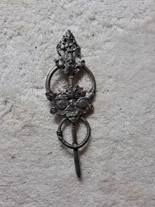 St Justin pewter broach.