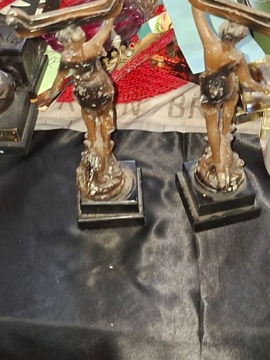 A Pair of Antique French Spelter Statues titled La Force (The Strength) and Le Pouvoir (The Power). The feature a male and female figure standing a top lions, raising up flaming torches