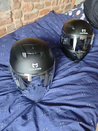 pair of helmets, one full face one open face