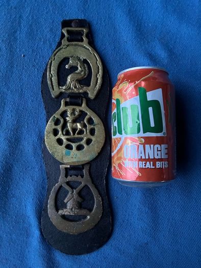 Vintage horse brasses on leather strap