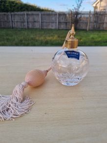Stuart crystal perfume bottle with atomizer and pink fringe.
