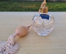 Stuart crystal perfume bottle with atomizer and pink fringe.