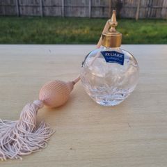 Stuart crystal perfume bottle with atomizer and pink fringe.