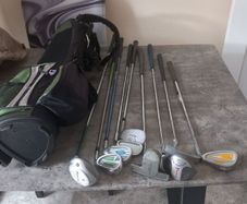 A selection of junior golf clubs and bag.