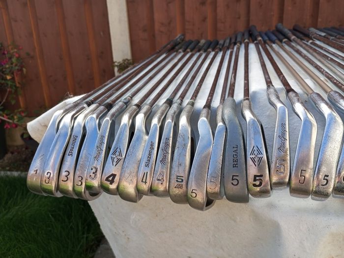 A selection of golf clubs and bags. All right handed clubs.