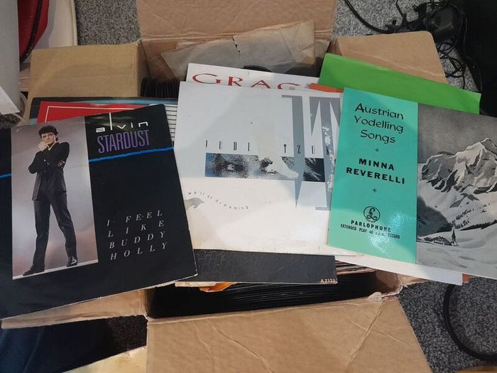 a box of 7" singles. 45 rpm vinyl records.