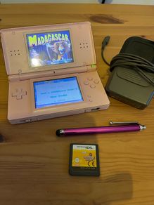 Pink Nintendo DS lite with charger and games