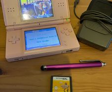 Pink Nintendo DS lite with charger and games