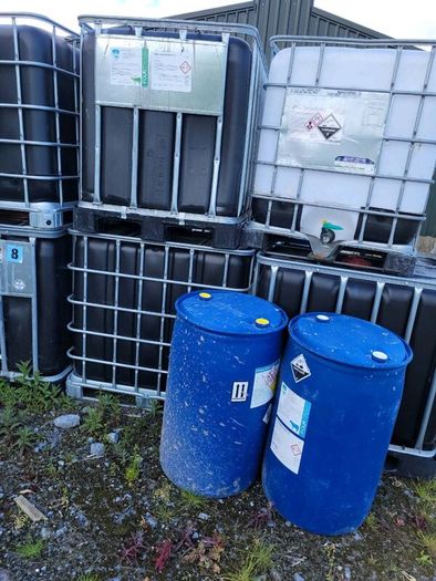 IBC tanks and blue barrels