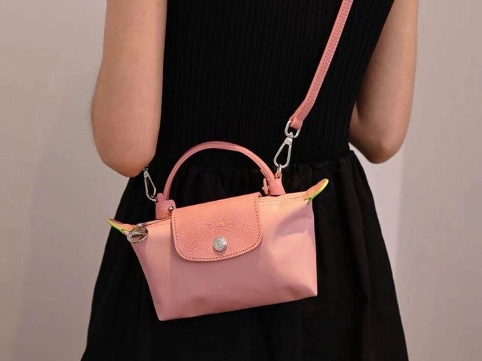 pink Longchamp Le Pliage mini top-handle bag with a detachable shoulder strap