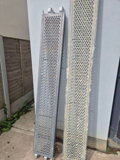 Two galvanised steel scaffolding planks