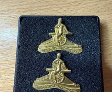 Vintage Irish Defence Forces Artillery Corps collar badges