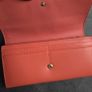 Michael Kors red and pink wallet with gold-tone MK logo. Multiple card slots and a zipped coin compartment. In perfect condition apart from some minor wear inside, which is not noticeable when using it, as shown in the photos. Image 8