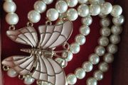 A beautiful faux pearl butterfly bracelet.