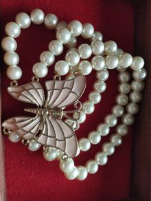 A beautiful faux pearl butterfly bracelet.