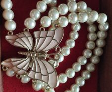A beautiful faux pearl butterfly bracelet.