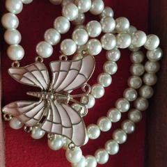 A beautiful faux pearl butterfly bracelet.