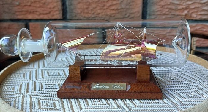 Blown Glass "Arabian Dhow" Sailing Ship Housed in Clear Glass Bottle.
