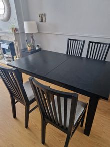 Black dining table with four chairs