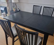 Black dining table with four chairs