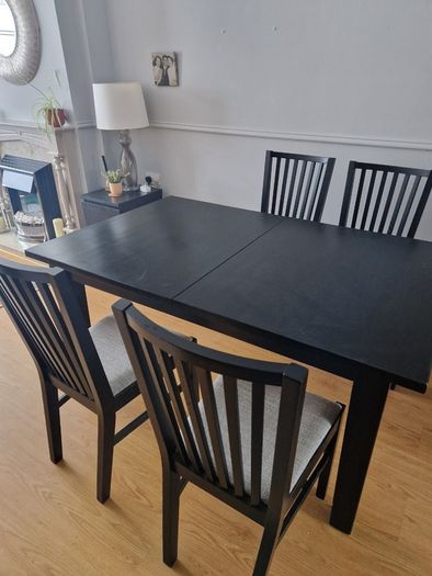 Black dining table with four chairs