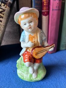 Vintage ceramic figurine of a young Boy Playing a Mandolin