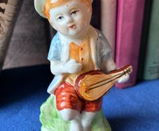 Vintage ceramic figurine of a young Boy Playing a Mandolin