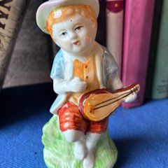 Vintage ceramic figurine of a young Boy Playing a Mandolin
