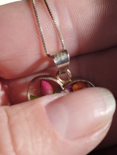 Handcrafted 925 sterling silver necklace with a heart-shaped pendant featuring a floral pattern.