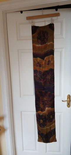 Hand painted, 100% silk scarf featuring a hand-rolled hem and custom metallic gutta detailing.