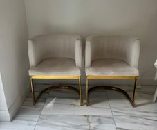 Cream and gold armchairs