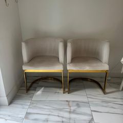 Cream and gold armchairs