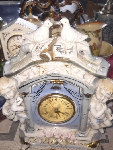 Porcelain Mantel Clock with Two Cherubs and Two Doves on top, and floral accents, Postage Available